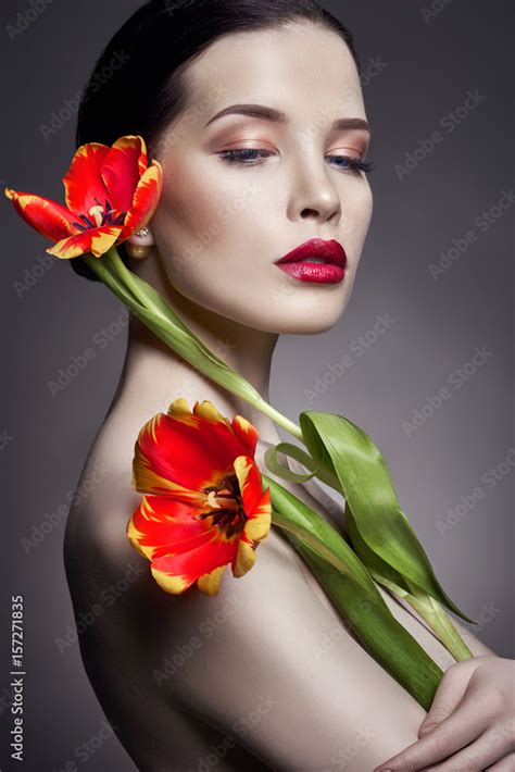 Nude Naked Girl With Tulips Flowers In Hand And Perfect Skin Sexy