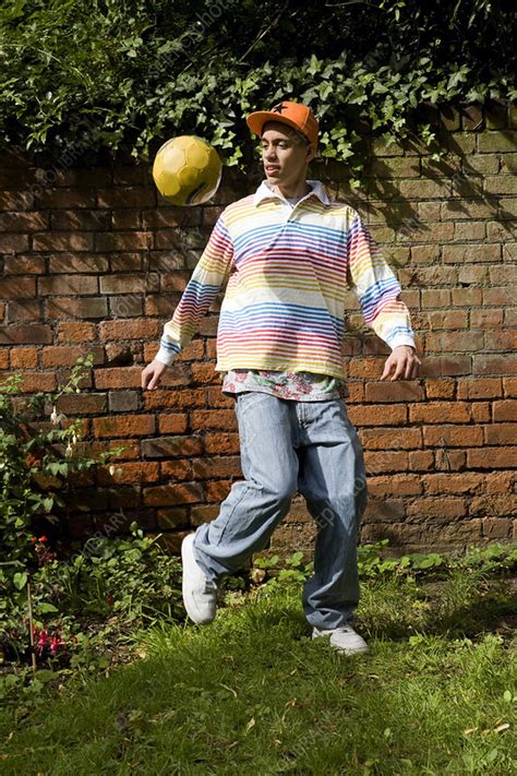Mixed Race Teenager Playing Football Stock Image F003