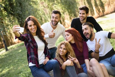 girl taking a picture of herself and her friends photo