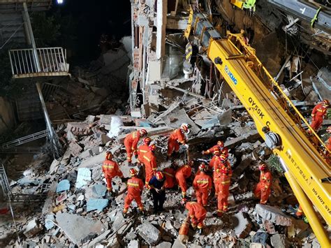 china hotel collapse kills eight rescuers search for nine