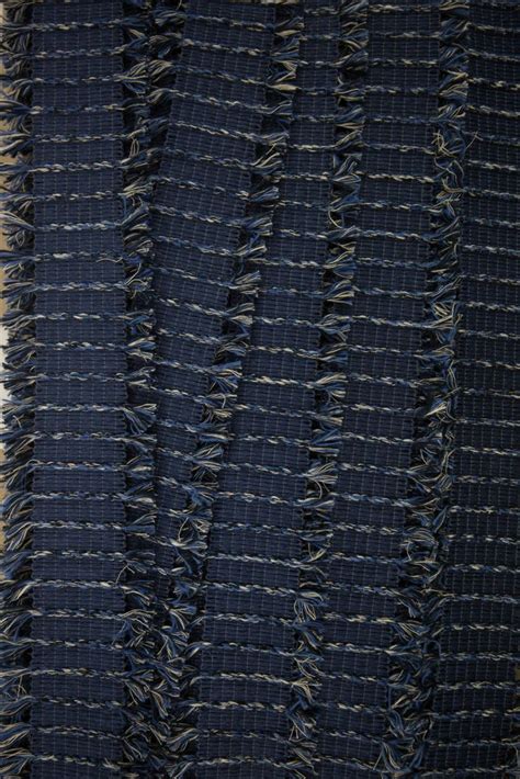 upholstered blue rug  fringes