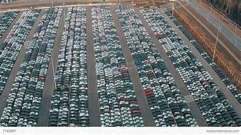 flying above storage parking lot of new unsold cars stock