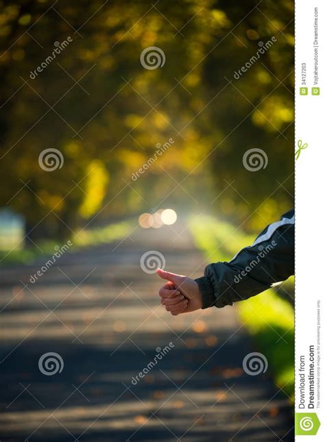 hitchhikers hand trying to stop a car on the autumn road stock image image of nature hiking