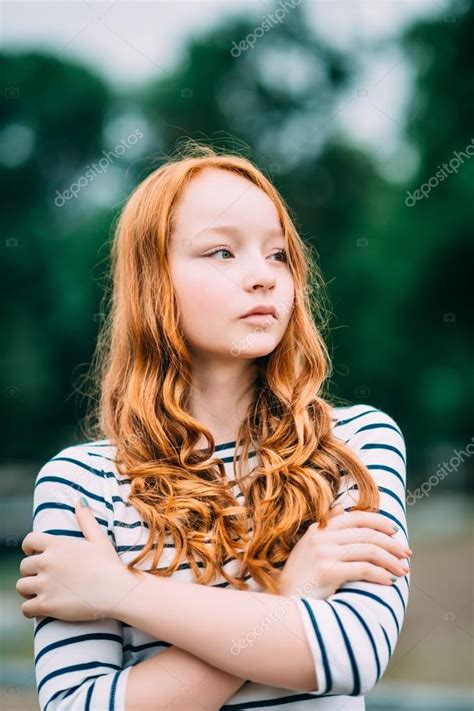 Outdoor Portrait Of Pretty Red Haired Girl With Green Eyes Who Hugging