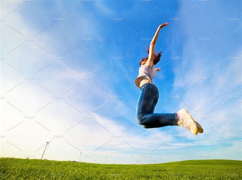 woman jumping  joy   field high quality people images