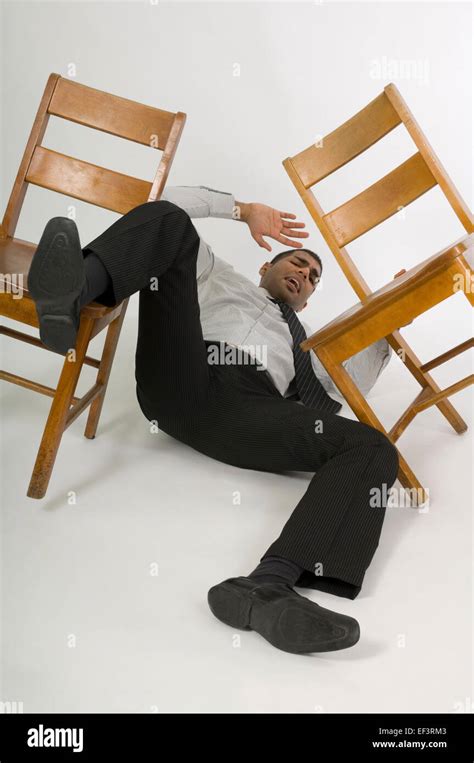 man falling   chair stock photo  alamy