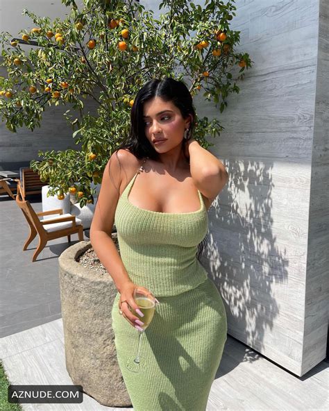 kylie jenner sexy shows off fake boobs and booty wearing a tight dress