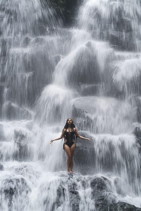 Girl In Swimsuit Standing Under Waterfall Vertical Oriented By
