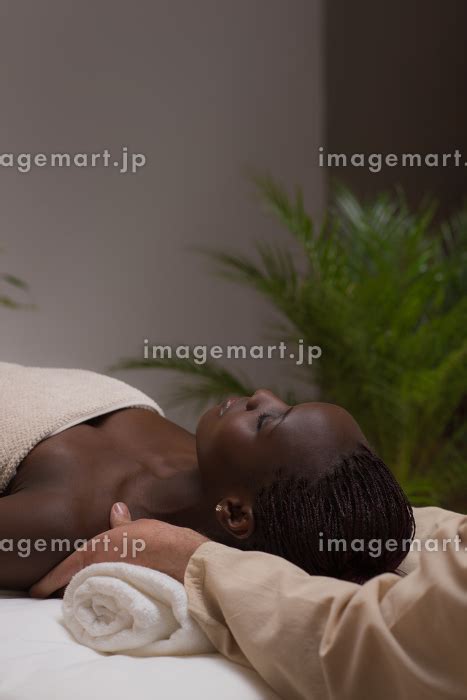 Portrait Of Young Beautiful African Woman In Spa Environment Getting