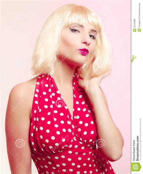 Beautiful Pinup Girl In Blond Wig And Retro Red Dress