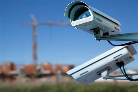 security cctv camera  surveillance system  construction site  blurry background stock