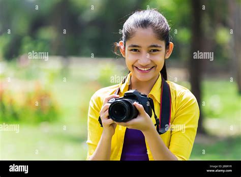 happy  indian young girl photographer camera photography  park stock