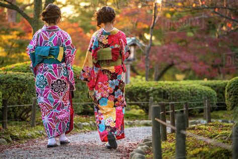 Rear View Of Two Women Wearing Colourful Traditional Japanese Kimonos