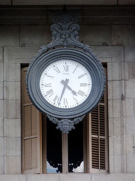 eye catching clock   facade   ayuntamiento de barcelona  barcelona catalonia clock