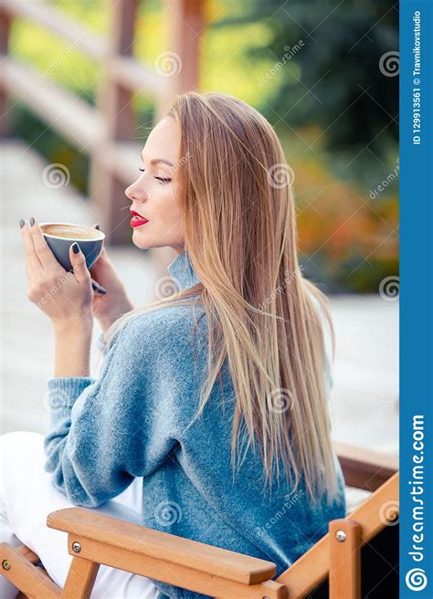fall concept beautiful woman drinking coffee in autumn