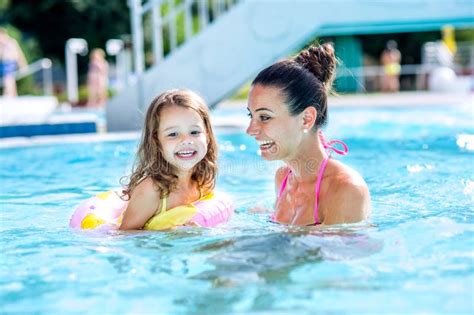 Mother And Daughter In Swimming Pool Aquapark Sunny Summer Stock