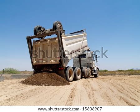 dump truck  dumping  mound  dirt   excavation site