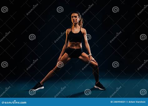 Healthy Strong Woman Stretching And Warming Up Her Legs With Closed