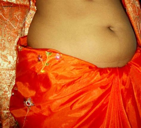 desi lady in orange saree blouse showing boob curves and navel pics 1