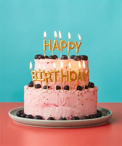 happy birthday cake  lit candles  stocksy contributor marti sans stocksy