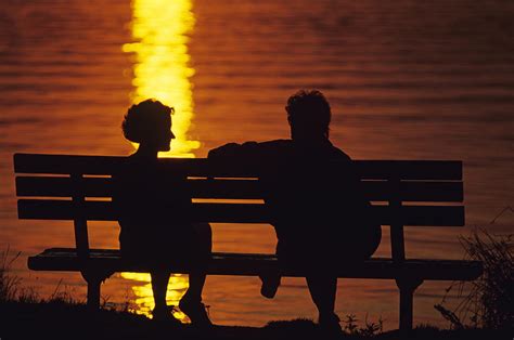 silhouetted couple on park bench tif photograph by jim corwin