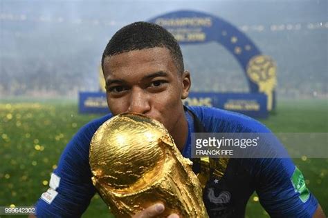 france s forward kylian mbappe kisses the world cup trophy after the