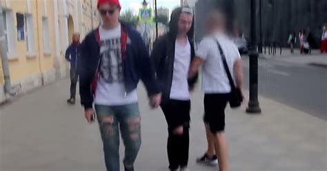 two men hold hands and walk through moscow the