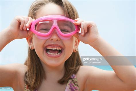 caucasian girl in bathing suit adjusting goggles photo getty images