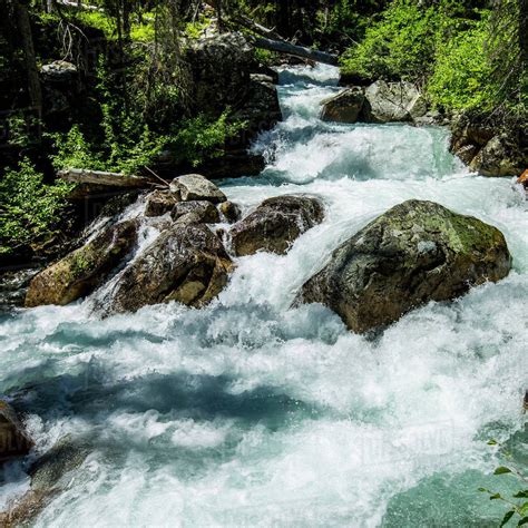 river rapids flowing  rocks stock photo dissolve