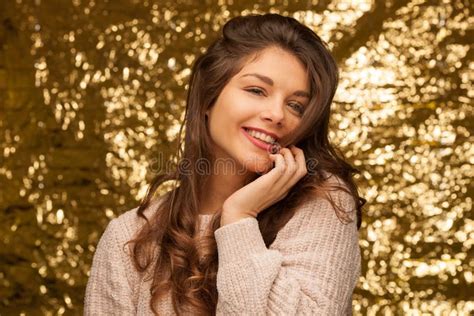 Beauty Portrait Of A Cute Brunette Teenager Over Golden Sparkling
