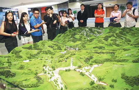 visitors look at a model of the terrain in zhangjiakou