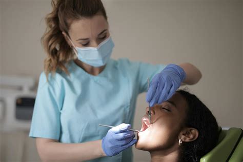 young female dentist treating teeth  female patient  modern clinic