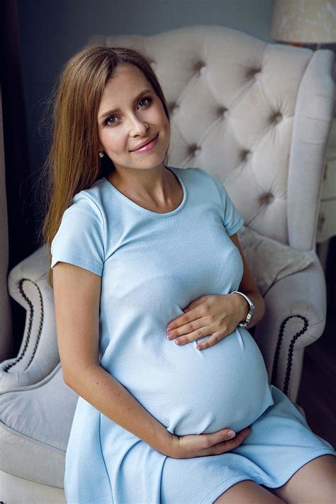 Pregnant Young Girl In Blue Dress Sitting On Chair Photograph By Elena