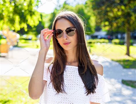beautiful brunette fashion style wearing glasses and a white blouse model glamor business