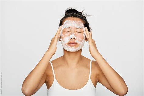 Young Beautiful Asian Woman Washing Her Face By Stocksy Contributor