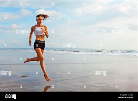 Barefoot Sporty Girl With Slim Body Running Along Sea Surf By Water
