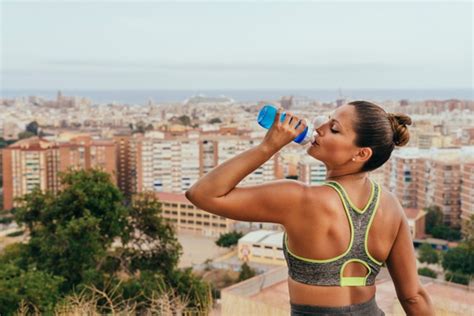 Free Photo Sportswoman Drinking Water After Training