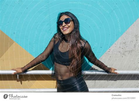 Brunette Girl Posing As A Model In Front Of A Colorful