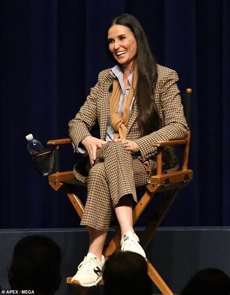 demi moore is business like in brown check pant suit as she discusses