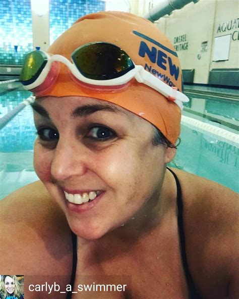 A Woman Wearing An Orange Swimming Cap And Goggles