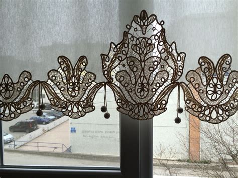 intricately designed window valance hangs  front   large window  cars