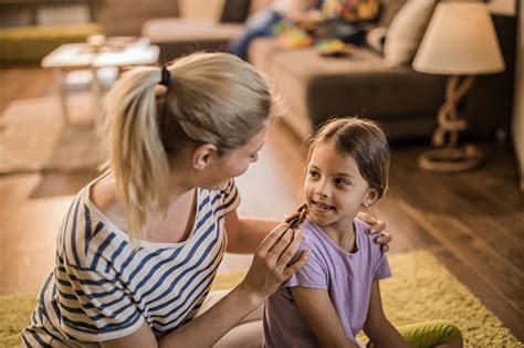 loving mother and daughter talking to each other at home