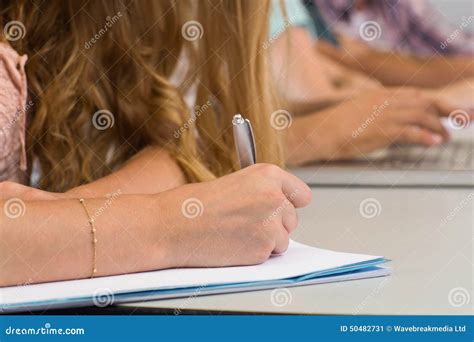 students writing notes  classroom stock image image  class desk