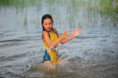 girl splashing  water stock photography image