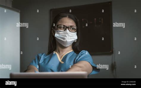 tired medic looks thoughtfully at side pensive female doctor thinks