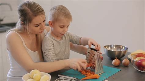 mom teaches son to cook with carrots loving stock footage sbv 332122183