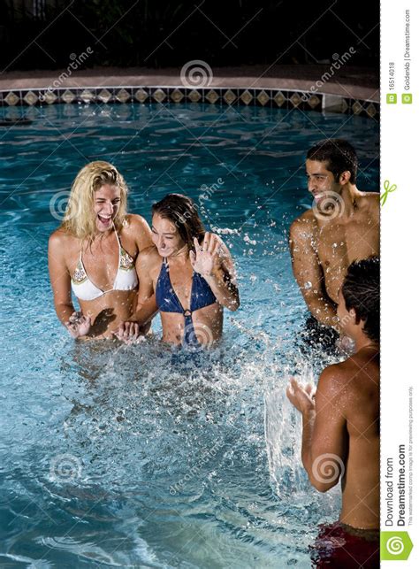 Two Couples In Swimming Pool At Night Royalty Free Stock