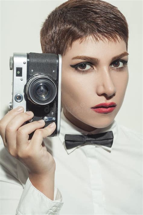 Young Beautiful Woman With Short Hair Style And Classic Wear With Bow