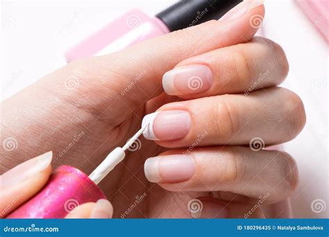 manicure  woman paints  nails  girl applies nail polish
