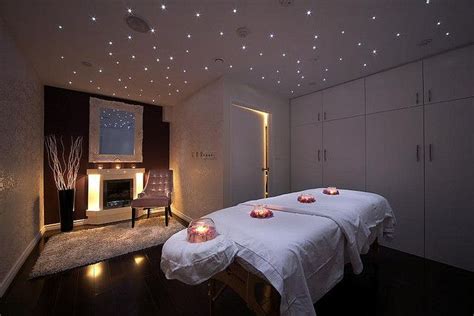 Two Beds In A Room With Lights On The Ceiling